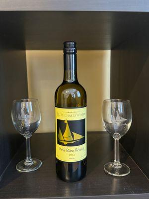 Vidal Blanc reserve along side two customized St. Michael's wine glasses (with the sails)