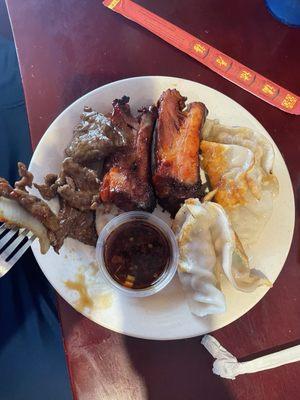 My boyfriends plate of dumplings, ribs, and beef