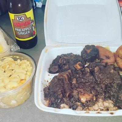 Oxtail Platter, Mac n Cheese and Jamaican soda.