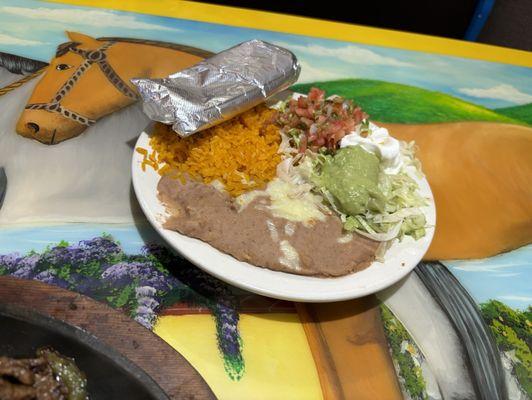 Rice beans guacamole salsa lettuce and tortillas.