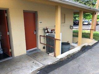 The outside of my room. That's right, a busted tricycle and refrigerator sitting outside my door. Not like their pics