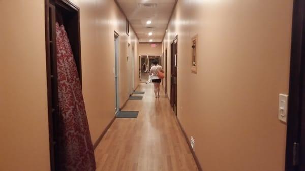 Inside of the spa. Narrow hallway. There are many massage rooms on the left side of the wall.