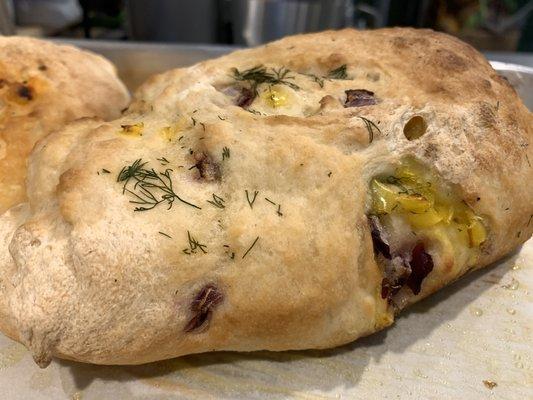 A gorgeous Artisan Specialty Loaf! Each week is different. This is a mixed herb, banana pepper and red onion!