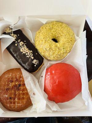 Boston Crème (upper left); Butter Pistachio (upper right); Crème Brûlée (bottom left); Raspberry Glazed (bottom right)!