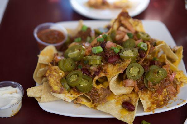 Massive nachos with chili. Excellent ratios and layered toppings. Class.