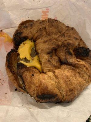 Burnt, smashed sausage egg and cheese croissant.