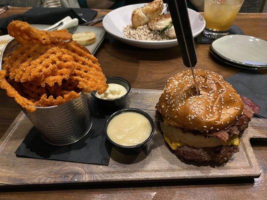 Smash burger and sweet potato waffle fries with maple sauce