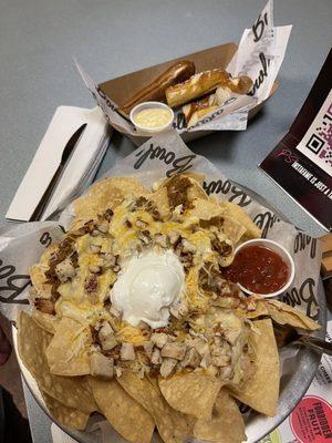 Loaded nachos with chicken and beef, pretzel bites