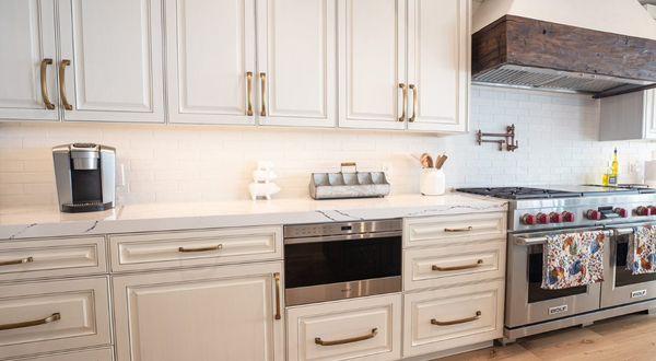 This Temecula CA Luxury Level Painted Kitchen Features Frameless European Cabinetry with Raised Panel Doors, and Marble Countertops.