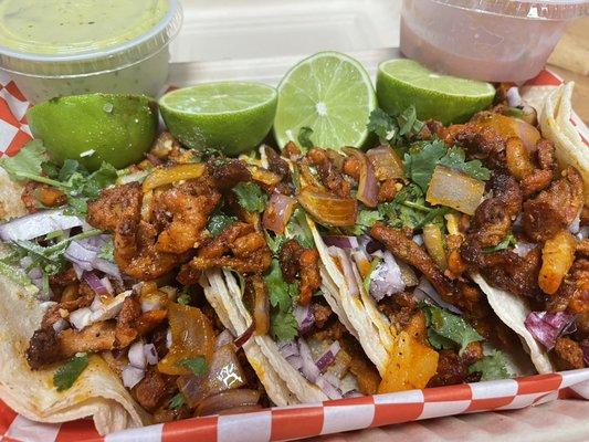 Pastor tacos with onions  and cilantro guacamole and red salsa