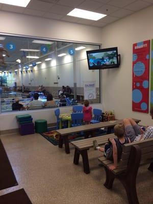 Waiting area keeps kids entertained complete with books , puzzles and a tv