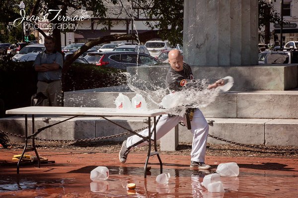 Master Phil Ross cutting through three, one gallon jugs in a demonstration.