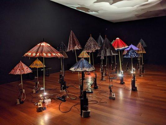 Moving art - the umbrellas are attached to motors that open/close them