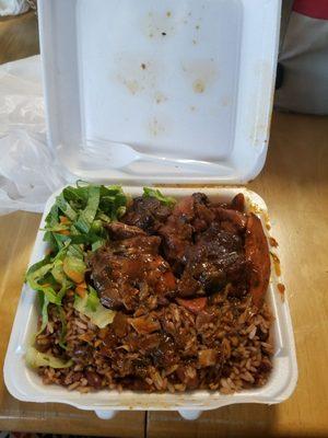 Yummy lunch special $4.99 Brown stew chicken with rice and peas and salad