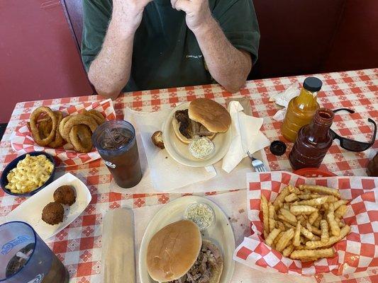 Beef brisket sandwiches fries onion rings Mac & cheese and homemade hush puppies