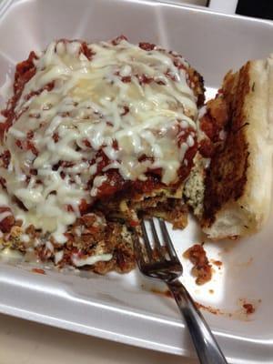 Takeout lasagne with garlic bread.