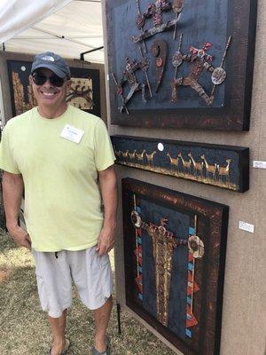 Artist Rob Sternberg beside a few of his pieces.