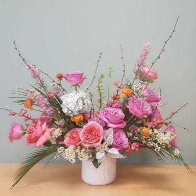 Pink and purple garden roses, garden style arrangement in white vase (large arrangement)