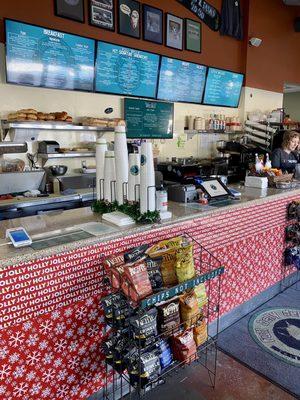 Front counter , menu is on blue board above.