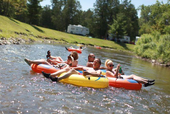 Campers tubing down river