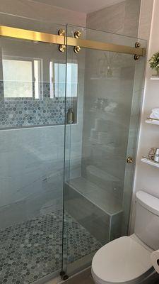 Bathroom shower door with barn door fixture