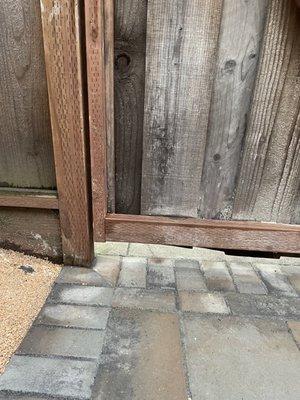 They had to cut part of the gate because they didn't take the swing of the gate into account when placing the pavers