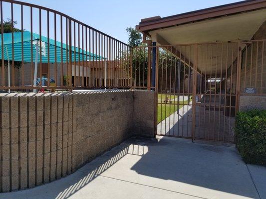 Coded security gate to enter school area (door 1 of 2)