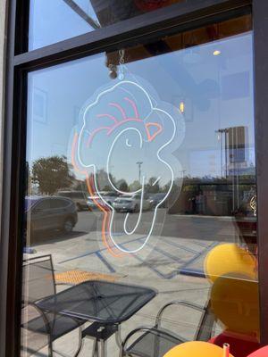 Chicken G's Neon Logo light on their window.