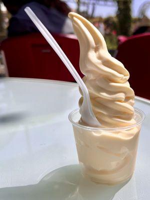 Dole Whip. Sweet and tangy pineapple flavored soft serve, piled up high in a small cup.