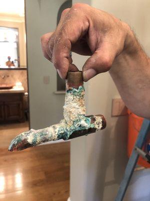 Old hot water pipe with pin hole leak (calcium buildup over time)