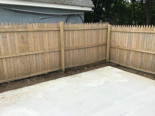 Fence after power washing and repair.