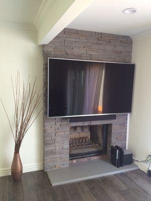 TV mounting on slate fireplace.