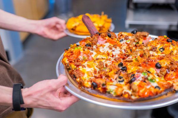 Red Sauce, Pepperoni, Ham, Italian & Portuguese Sausage, Bacon, Red Onions, Mushrooms, Tomatoes, Green Onions & Black Olives.