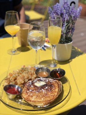 Buttermilk pancake, breakfast potatoes, and some orange mimosa.