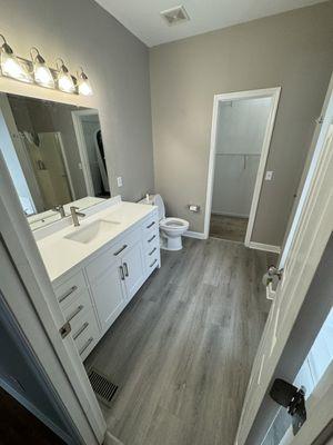 New flooring, toilet, vanity, faucet and light