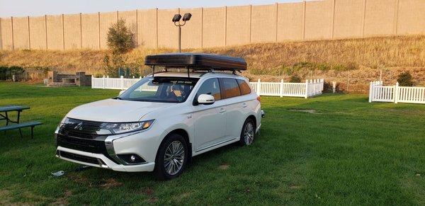 My suv with the tent set for traveling on the roof ..campsite in Utah  on our trip.. plugged in and charging..