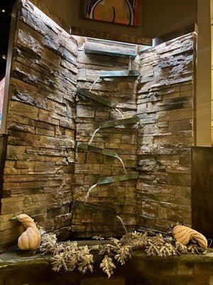 Unique waterfall fountain between back bar and dining area