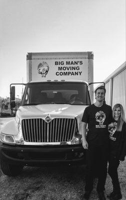 The owners, Josh and Brooke Anderson in front of one of their moving trucks.