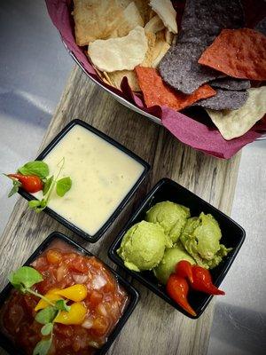 Tricolored tortilla chips with pita chips and your choice of salsa, guac, queso, or mix-and-match!