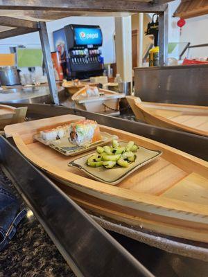 More pictures of sushi on a cute boat