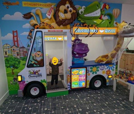 The coolest waiting room with a play kitchen and video game station