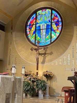 Stained glass windows behind altar