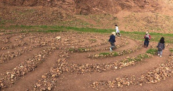 Kids run through a rock maze