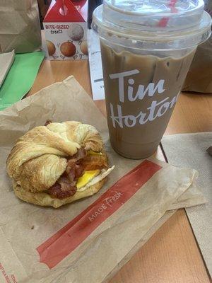 Bacon, egg, and cheese croissant with an iced mocha