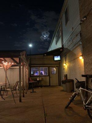 outdoor patio with tv in the corner for the game