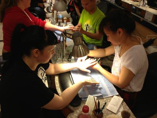 My wife getting her nails done. They look great!