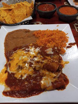 Three different enchiladas - cheese, chicken and beef with chili gravy and beans and rice. Two of their salsas with chips.