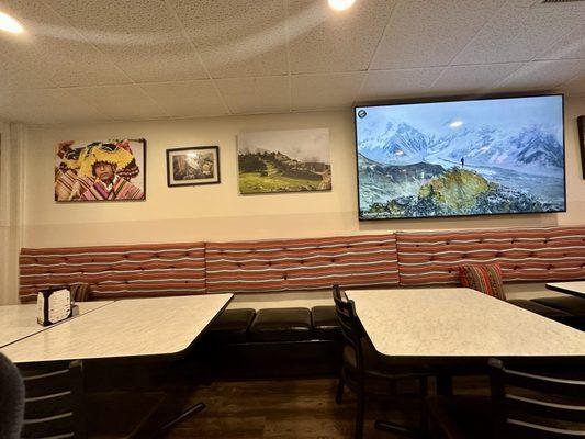 Dining area with flat screen television. They had a video playing that featured gorgeous mountain views.