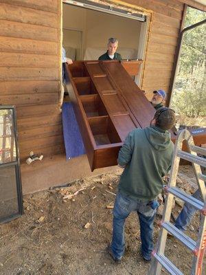 Delivering a BIG headboard after removing a section of windows. The headboard wouldn't fit down the hallway. It only added $200 to the job!