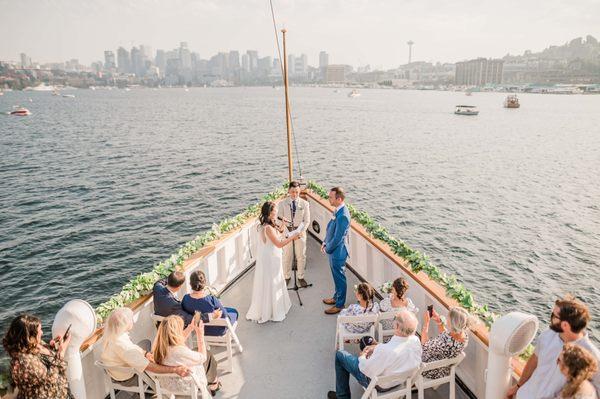 Wedding ceremony on the bow of the virginia v steamship in lake union